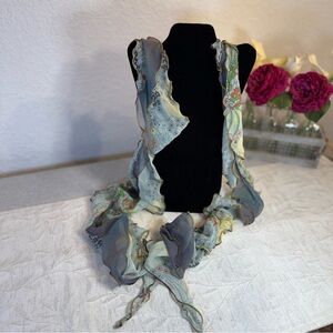 Ruffled edge ladies‎ scarf. Blue tones with yellow, coral and black flowers.